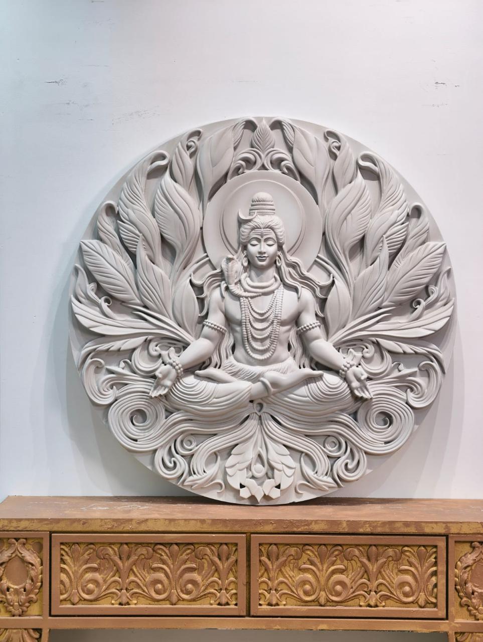 Round white relief of Shiva meditating inside an open lotus