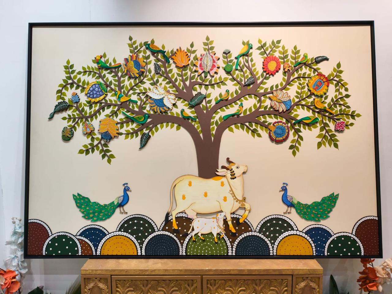 Carved tree of life with birds, a cow and peacocks